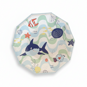 A round folding umbrella with a colorful underwater theme, featuring illustrations of a shark, turtle, fish, and starfish over wavy sea patterns on a white background.