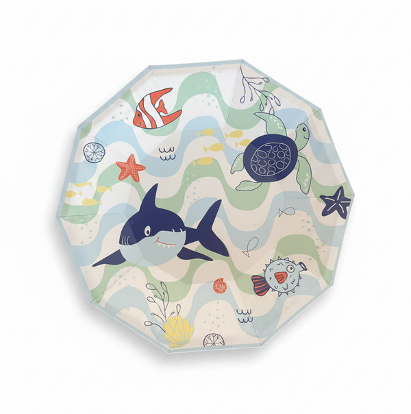 A round folding umbrella with a colorful underwater theme, featuring illustrations of a shark, turtle, fish, and starfish over wavy sea patterns on a white background.