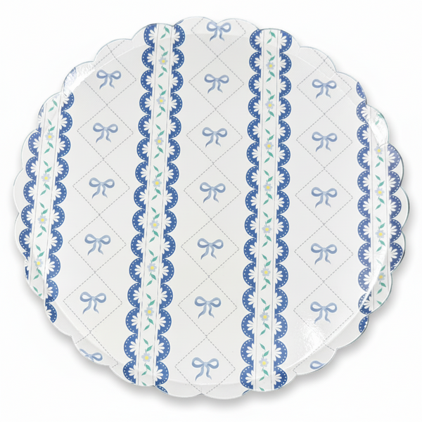 Close-up of blue bow scalloped paper plate design with floral details