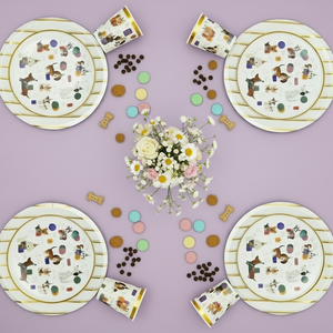 Set of paper plates and cups with dog illustrations on a purple background