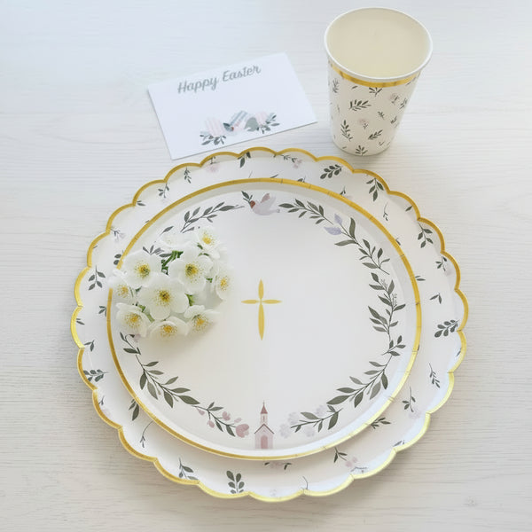 Easter-themed table setting with decorative plates, bunny ears, and a 'Happy Easter' card.