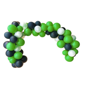 Balloon arch made of green, black, and white balloons