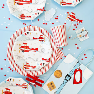 Children's party tableware with airplane design on a blue background