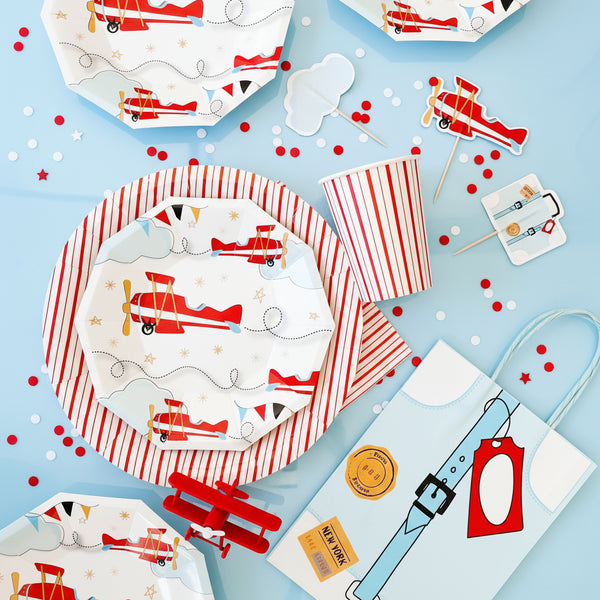 Children's party tableware with airplane design on a blue background